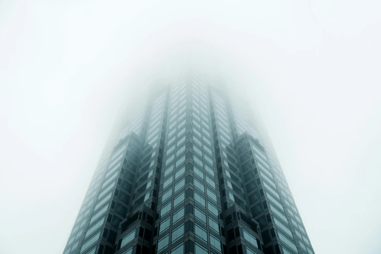 a tall building in the middle of a foggy sky, pexels contest winner, hypermodernism, sins inc skyscraper front, cyan mist, high resolution, multiple stories