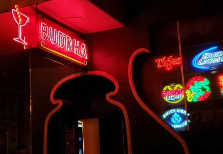 a neon sign hanging from the side of a building, buddha, inside a bar, 3delight, doorway