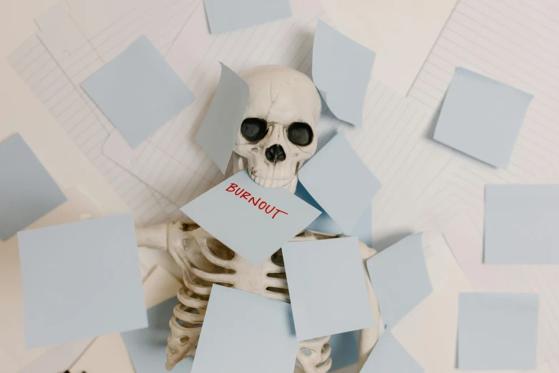 a skeleton sitting in a pile of post it notes, pexels contest winner, burnout, telegram sticker, background image, white scary skin