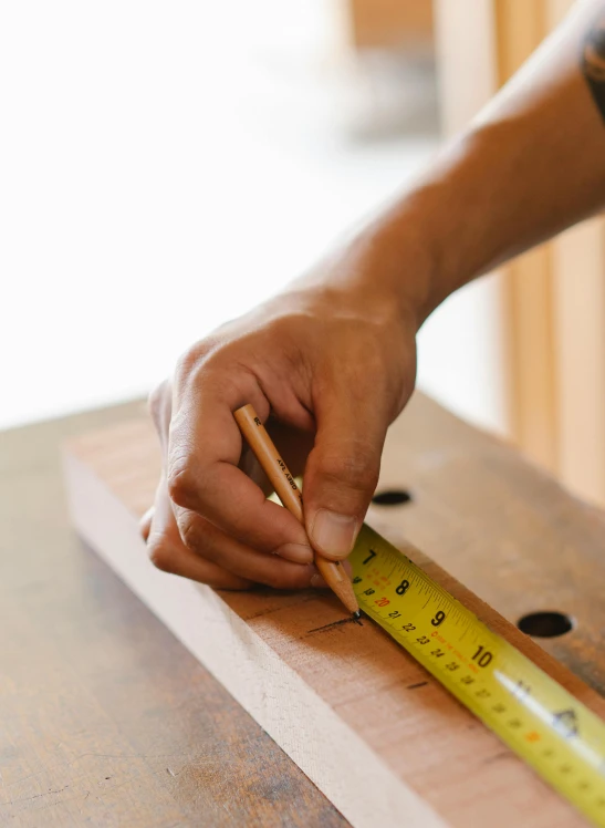 a person measuring a piece of wood with a ruler, unsplash, arbeitsrat für kunst, square lines, on, multi-part, small