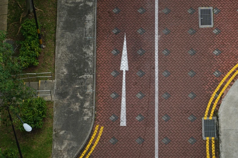 an overhead view of a red brick road, by Carey Morris, pexels contest winner, street art, arrows, taken with sony alpha 9, square lines, brown