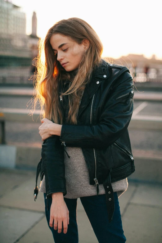 a beautiful young woman standing on top of a roof, inspired by Elsa Bleda, trending on pexels, wearing a black leather jacket, profile image, student, full product shot