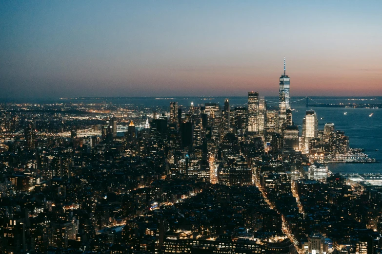 a view of a city at night from the top of a building, golden hour in manhattan, unsplash photography, background image