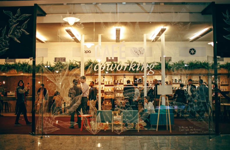 a group of people standing in front of a store, by Lee Loughridge, trending on unsplash, sitting in a cafe, branching hallways, caulfield, decorated