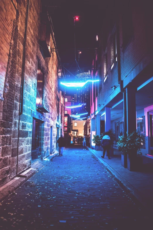 a couple of people walking down a street at night, an album cover, by Nick Fudge, unsplash contest winner, in chippendale sydney, blue neon accents, alley, dingy city street