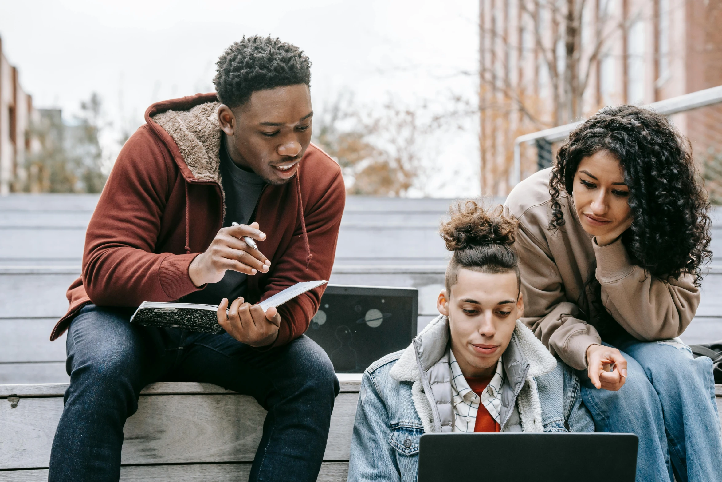 a group of people sitting on steps looking at a laptop, trending on pexels, essence, student, 1 4 9 3, thumbnail