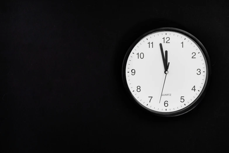 a black and white clock on a black wall, plain black background, background image