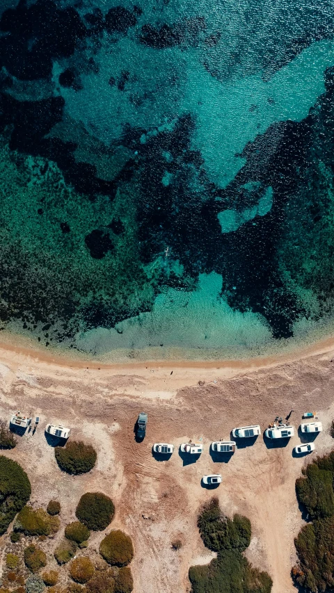 a large body of water next to a sandy beach, a screenshot, by Sebastian Spreng, trending on unsplash, top view of convertible, greece, 15081959 21121991 01012000 4k, boats