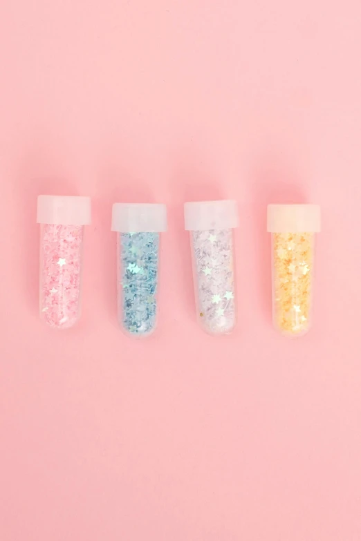 three bottles of glitter on a pink background, pixel art, inspired by Pearl Frush, trending on pexels, vials, kawaii aesthetic, 4 colors, pastel soft colors