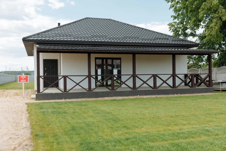 a small white house sitting on top of a lush green field, danube school, pavilion, professional photo, square, high quality image