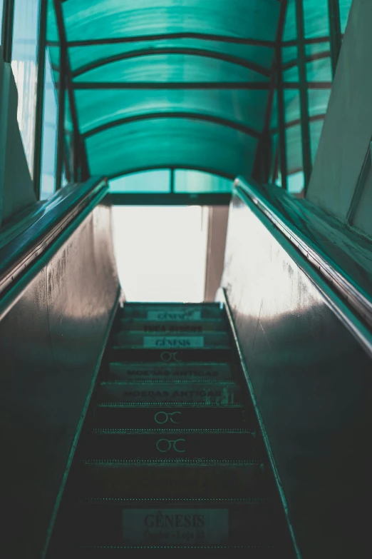 an escalator going up the side of a building, inspired by Elsa Bleda, unsplash, teal color graded, a green, stairs from hell to heaven, exiting store