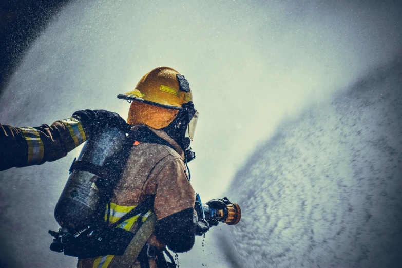 a firefighter spraying water with a hose, a colorized photo, by Alison Geissler, pexels contest winner, figuration libre, extreme cold, profile image, avatar image, high quality wallpaper