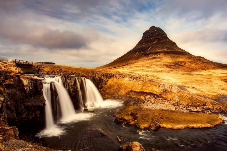 a waterfall with a mountain in the background, by Hallsteinn Sigurðsson, pexels contest winner, romanticism, golden hues, islamic, medium format, historical photo