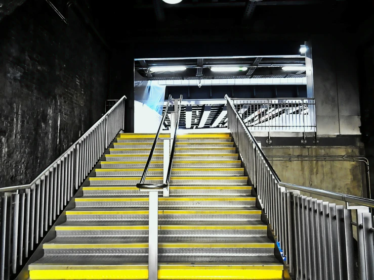 a set of stairs leading to a subway station, inspired by Andreas Gursky, unsplash, happening, yellow and charcoal, square, stadium, manchester