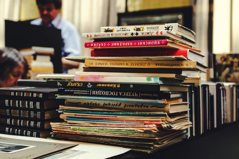 a stack of books sitting on top of a table, a photo, librarian, messy, featured, readable