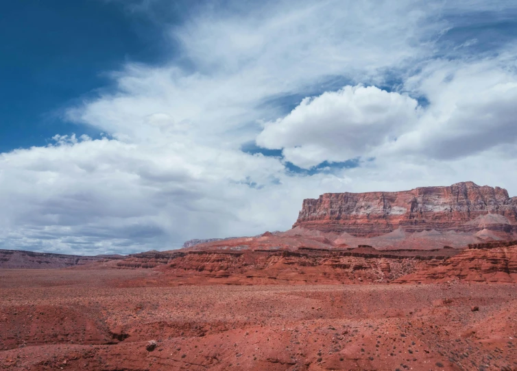 a large rock formation in the middle of a desert, unsplash contest winner, faded red colors, joel sternfeld, panoramic shot, mesa plateau