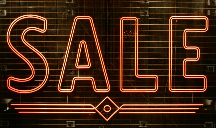 a neon sale sign in front of a brick wall, pexels, folk art, brown red and gold ”, images on the sales website, halogen, salt