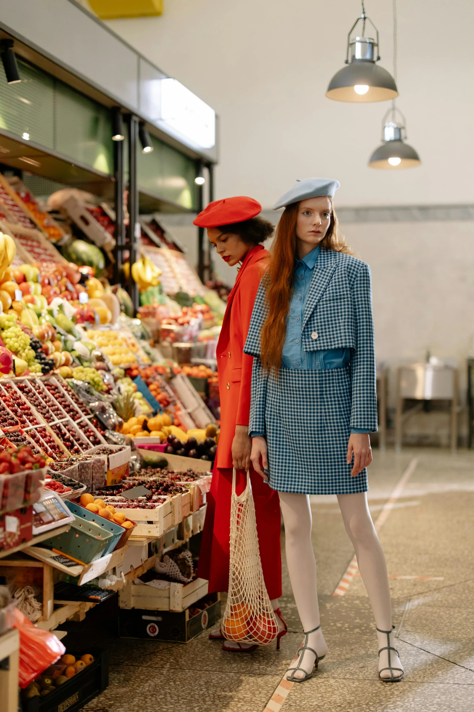 a couple of women standing next to each other in front of a fruit stand, trending on pexels, renaissance, blue coat, fashion editorial, inside a supermarket, inspect in inventory image