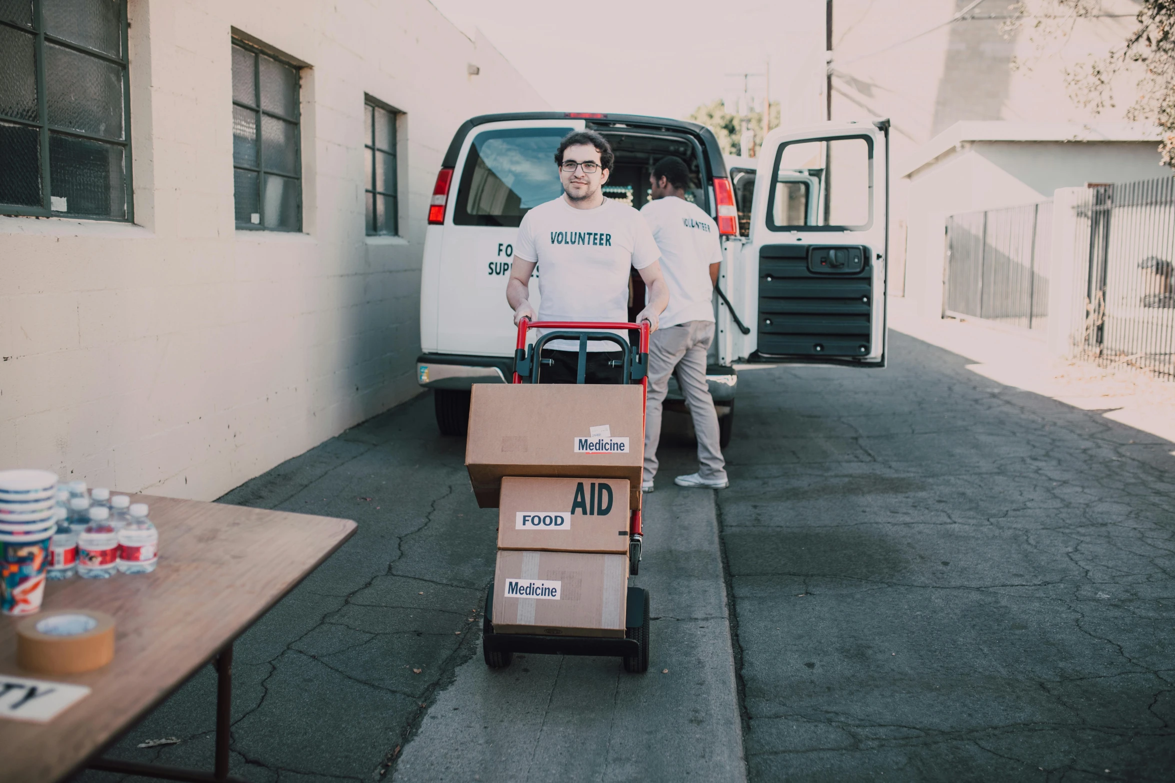 a man pushing a cart filled with boxes, a photo, pexels contest winner, pokimane, avatar image, lachlan bailey, long distance photo