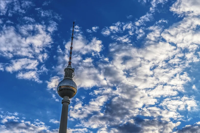 a very tall tower with a blue sky in the background, pexels contest winner, berlin secession, avatar image, tall fluffy clouds, fan favorite, 2045