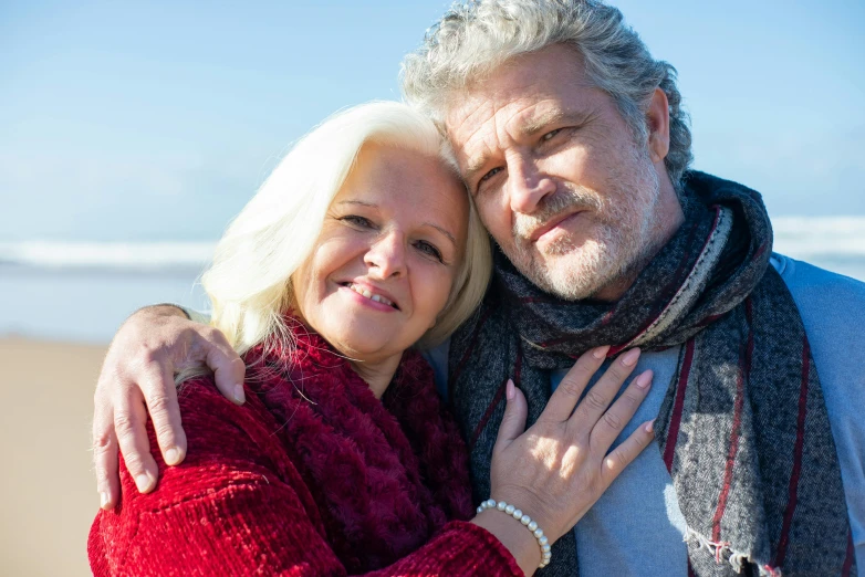 a man and woman standing next to each other on a beach, a photo, pexels, renaissance, white hair and beard, square, a cozy, peter paul rebens