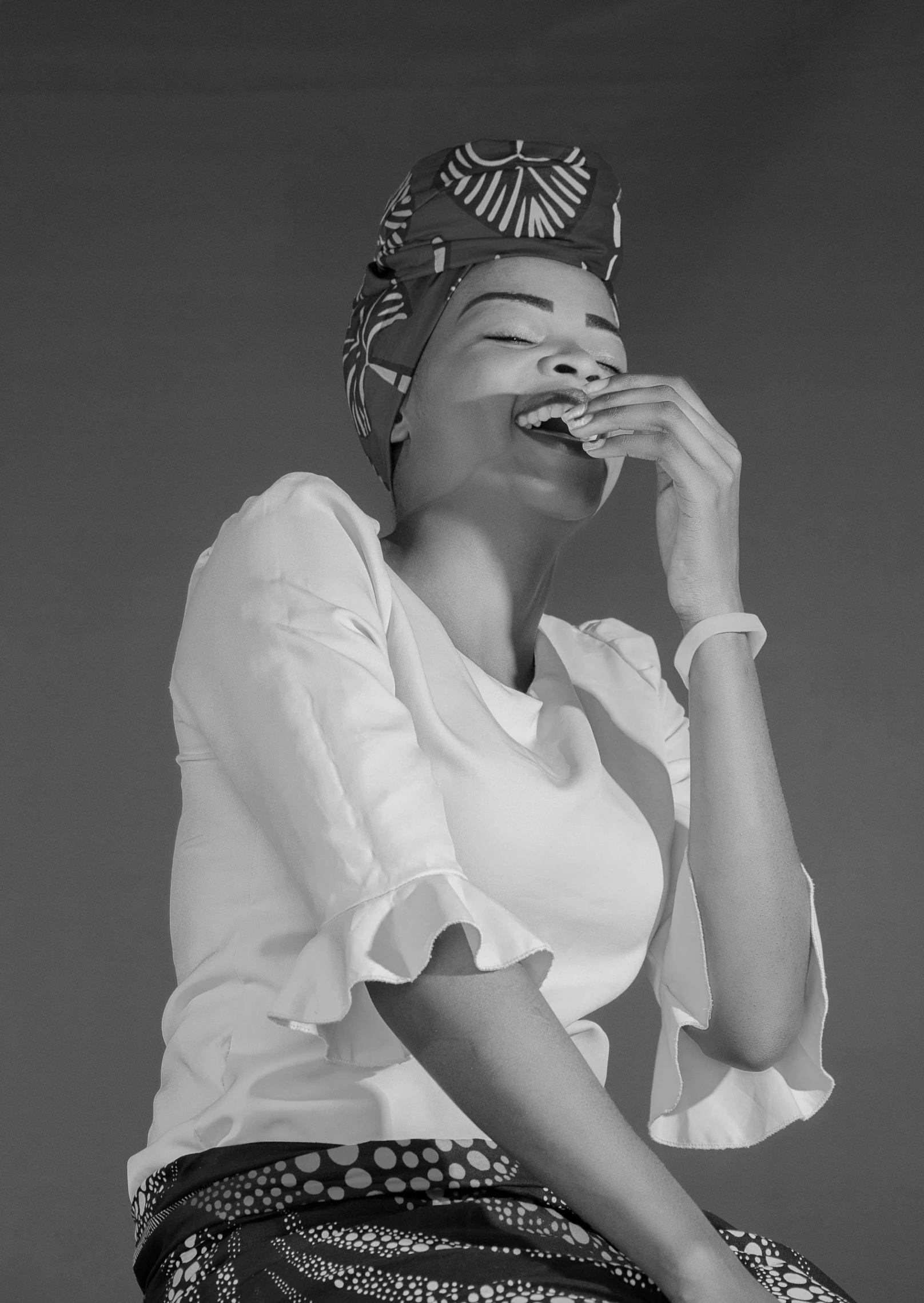 a black and white photo of a woman singing, a black and white photo, by Chinwe Chukwuogo-Roy, smiling fashion model, eating, turban, 15081959 21121991 01012000 4k