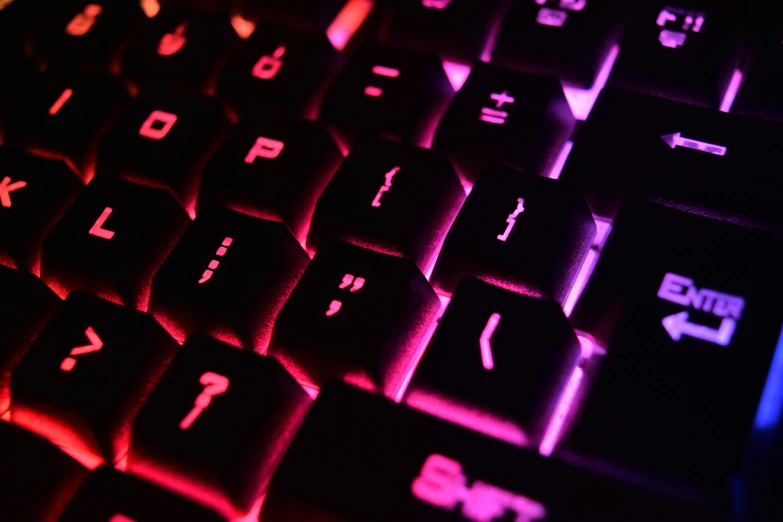 a close up view of a computer keyboard, by Adam Marczyński, pexels, computer art, fuschia leds, instagram post, volumetric lighting. red, glowing runes