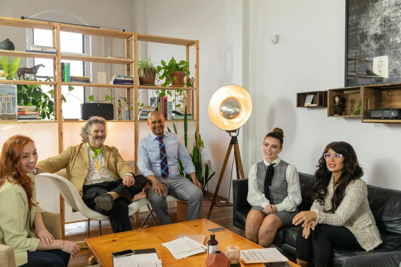 a group of people sitting around a wooden table, sitting on a desk, light source on left, avatar image, commercial photo