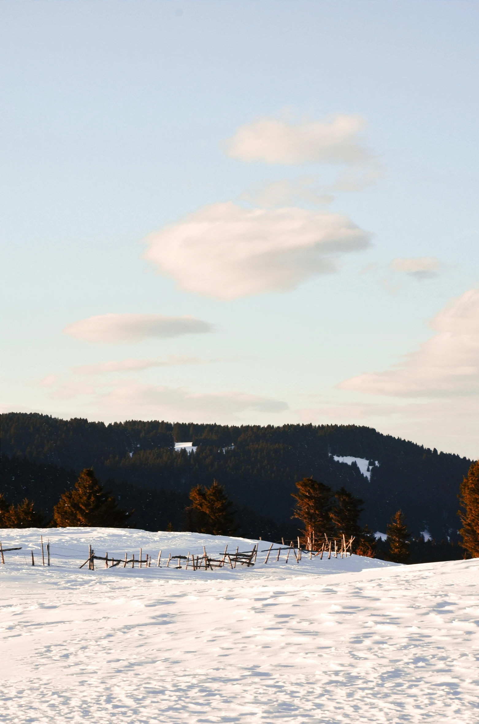 a man riding a snowboard down a snow covered slope, inspired by Einar Hakonarson, flickr, land art, castle made of clouds, distant - mid - shot, seen from a distance, a wooden