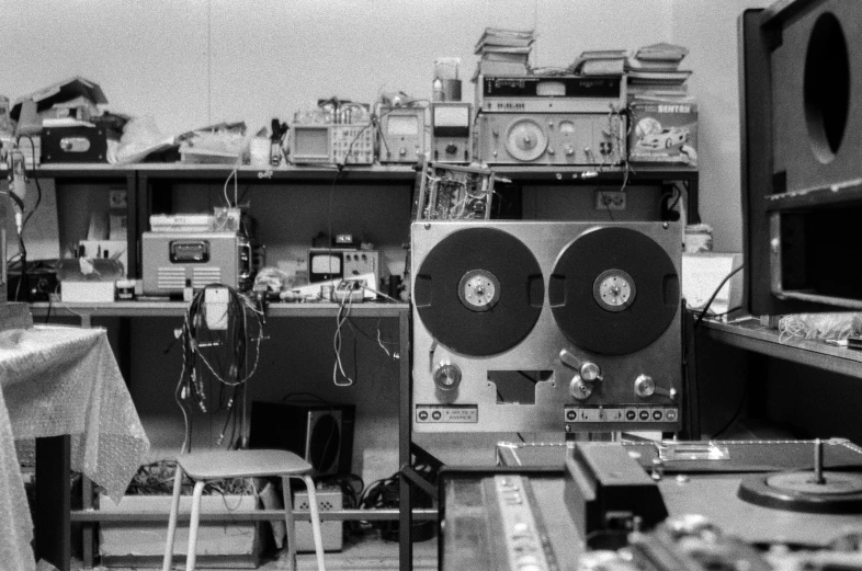 a black and white photo of a room full of electronics, tape deck, in a lab, ilford delta 3 2 0 0 pro, detail