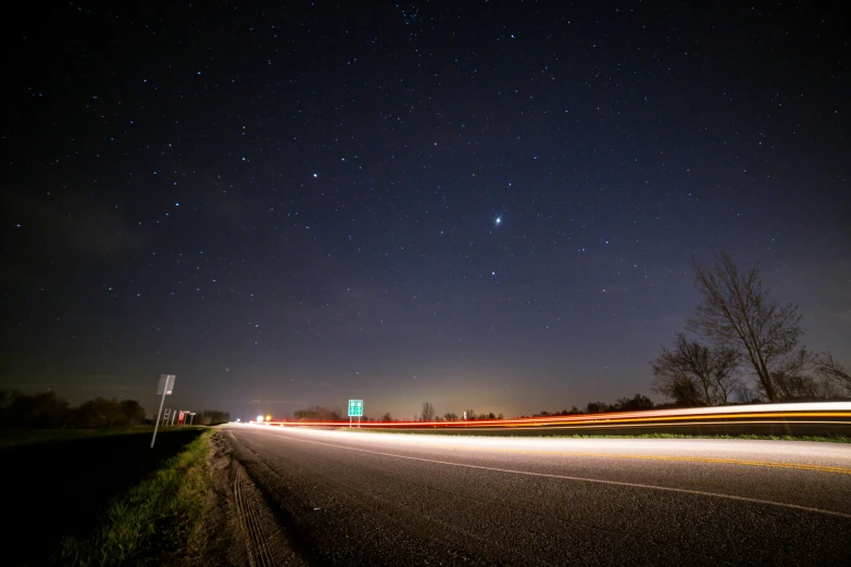 a long exposure photo of a highway at night, by Joe Stefanelli, stars and paisley filled sky, novi stars, mars in distance, high res photograph