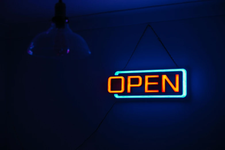a neon open sign hanging from the ceiling, pexels, happening, blue and orange rim lights, who can open the mind, profile image, open plan