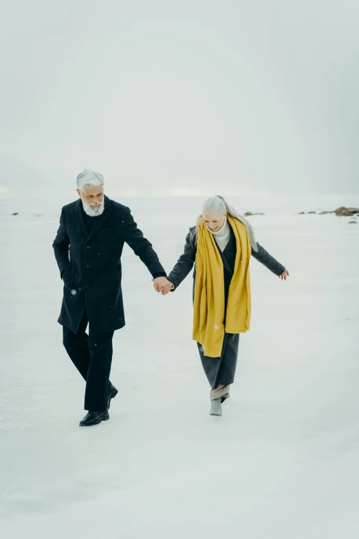 a man and woman walking in the snow holding hands, an album cover, by Jóhannes Geir Jónsson, unsplash, white hair and white beard, ( ( theatrical ) ), silver and gold, candid photography