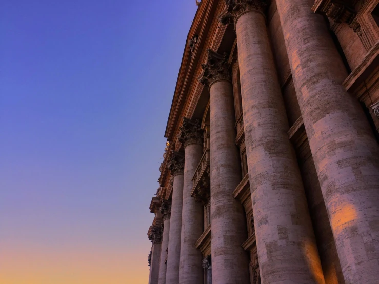 a clock that is on the side of a building, by Cagnaccio di San Pietro, pexels contest winner, neoclassicism, sunset view, colonnade, pope, profile image