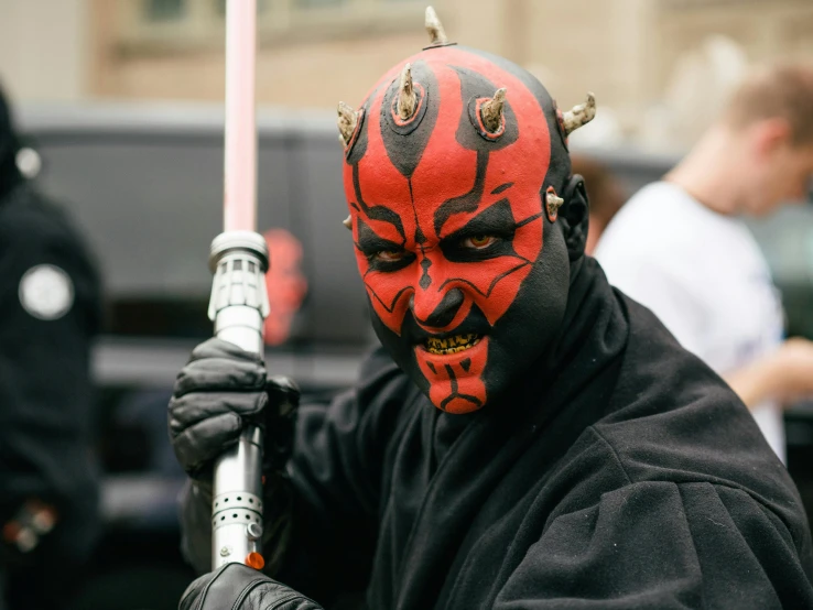 a man with a darth maul painted on his face, pexels contest winner, renaissance, holds a black sword, marvel comic book characters, still from star wars, kanye west as a jedi