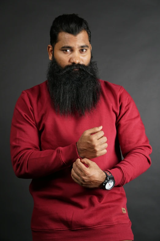 a man with a long beard wearing a red shirt, inspired by Sardar Sobha Singh, pexels contest winner, wearing a dark sweater, modeling, maroon and white, riyahd cassiem