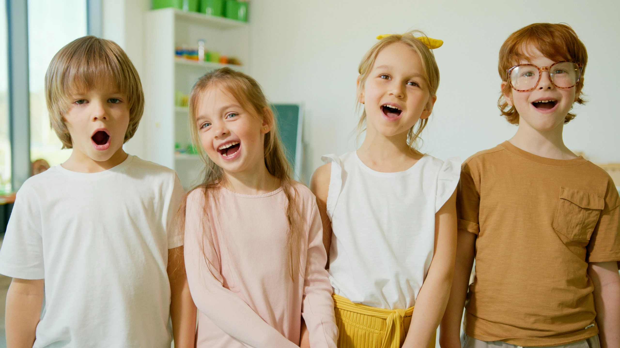 a group of young children standing next to each other, pexels, earing a shirt laughing, a girl with blonde hair, performing, looking straight forward