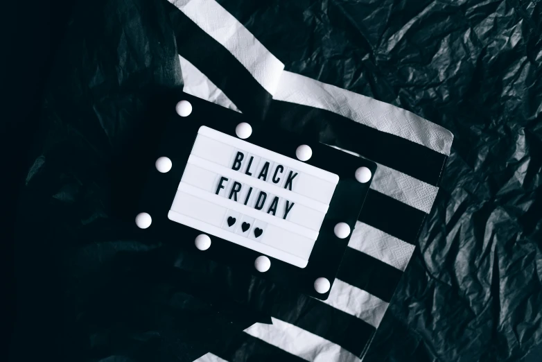 a black and white photo of a black friday sign, a black and white photo, by Julia Pishtar, pexels contest winner, costume, flatlay, blackout, holiday