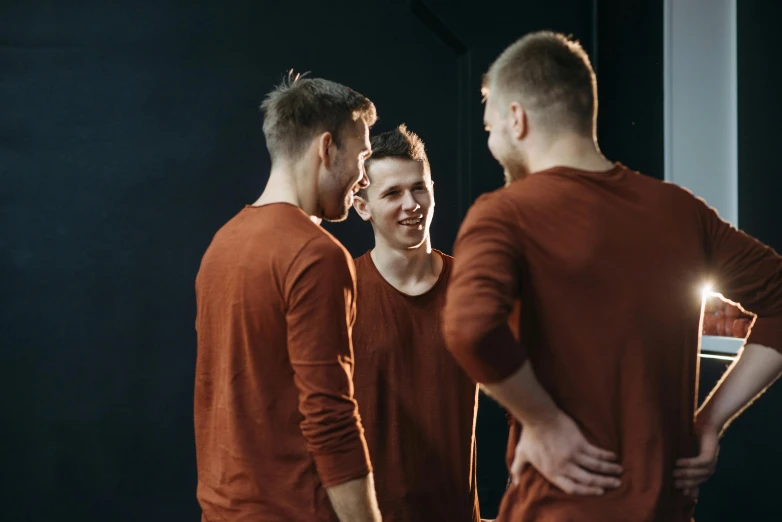 a group of men standing next to each other, by Anna Füssli, pexels contest winner, brown shirt, flirting, mirrored, avatar image