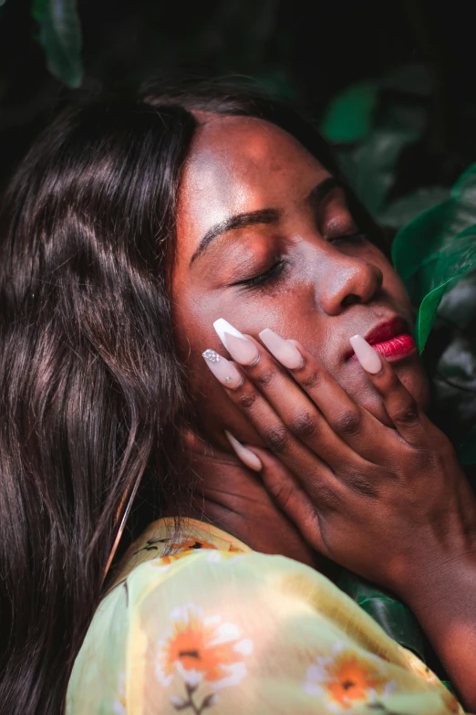 a woman with her hands on her face, inspired by Elsa Bleda, trending on pexels, afrofuturism, smooth waxy skin, hand on his cheek, lush paradise, long nails