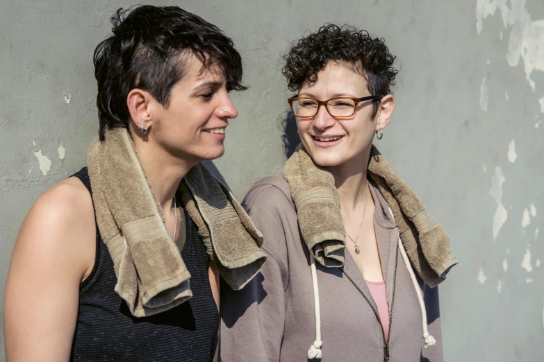 a couple of women standing next to each other, a portrait, by Nina Hamnett, shaven, close - up photo, looking happy, hila klein