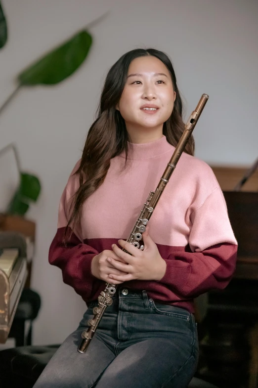 a woman sitting in front of a piano holding a flute, by helen huang, pokimane, holding an epée, wholesome, reuben wu