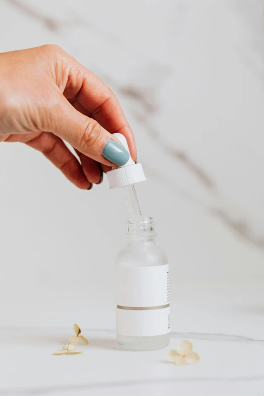 a person using a toothbrush to clean a bottle of toothpaste, by Nicolette Macnamara, trending on pexels, botanicals, with an iv drip, set against a white background, miniature product photo