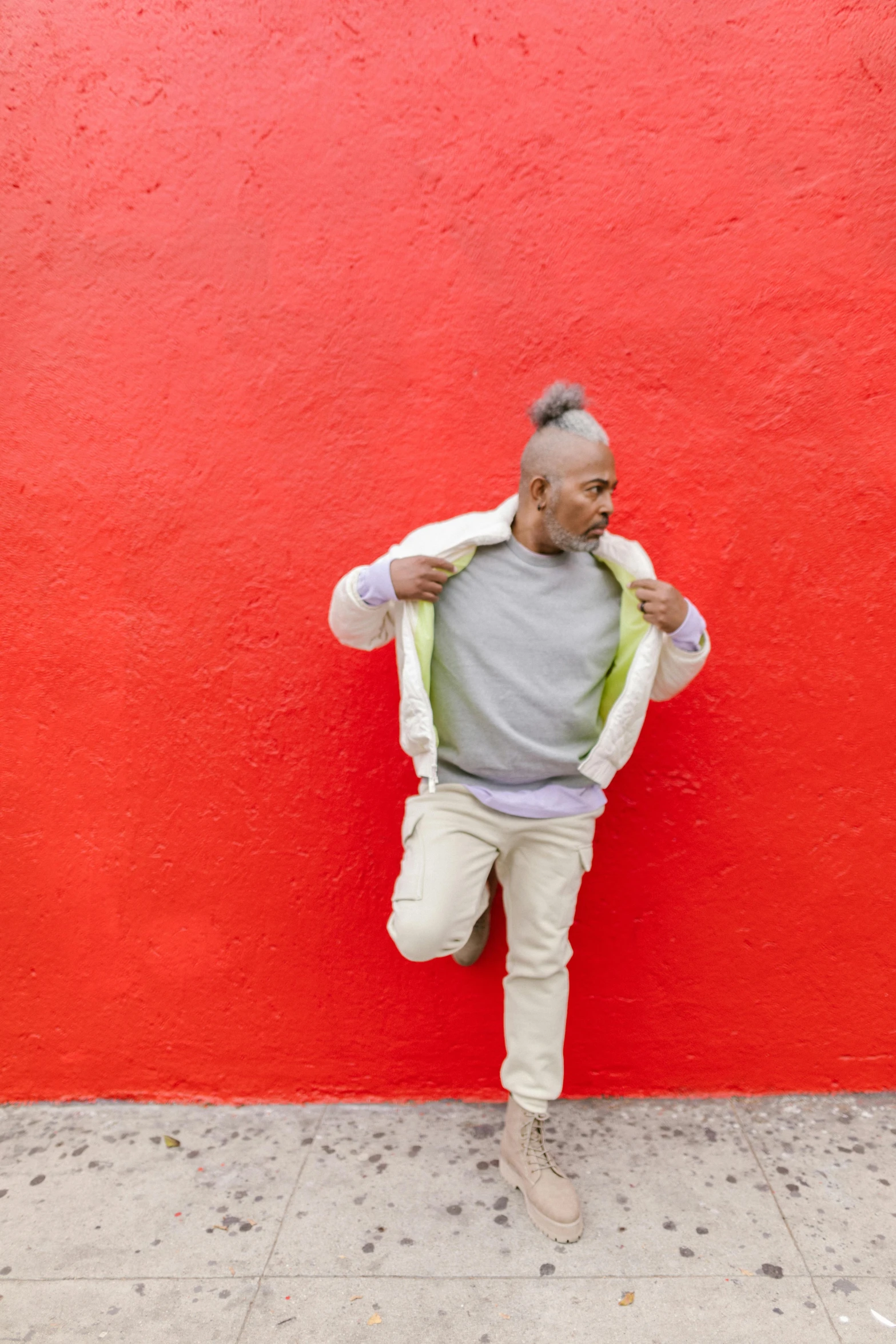 a man standing in front of a red wall, happening, pops of color, grey skinned, white background, ashteroth