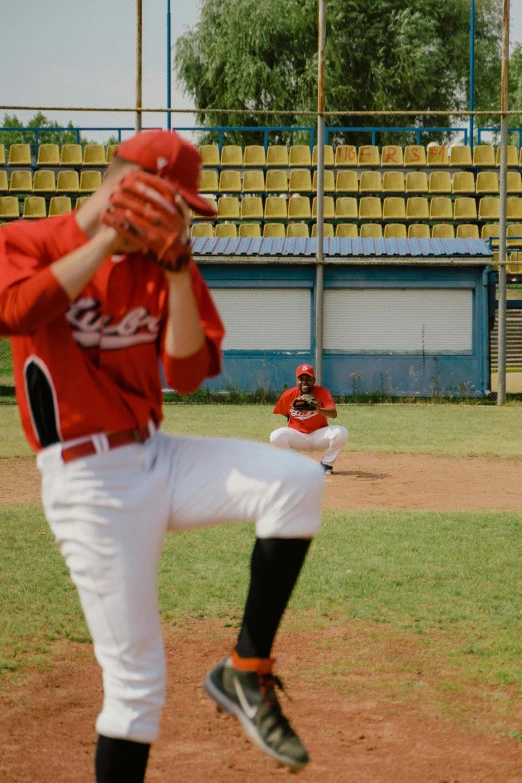 a baseball player pitching a ball on top of a field, a picture, shutterstock, figuration libre, cinematic wide shot, square, red uniform, 15081959 21121991 01012000 4k