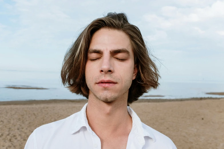 a man with his eyes closed on the beach, trending on pexels, renaissance, mid - length hair, adam narozanski, square masculine jaw, meditating