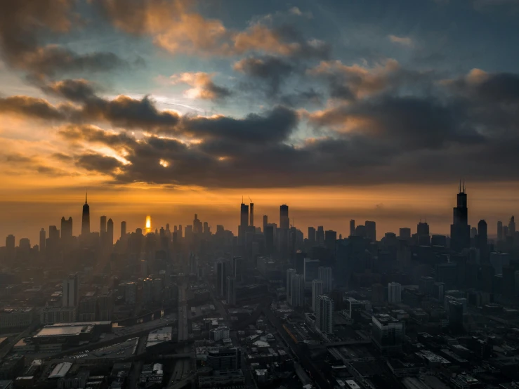 an aerial view of a city at sunset, by Andrew Domachowski, unsplash contest winner, hurufiyya, chicago skyline, cloudy sunset, 2 0 2 2 photo