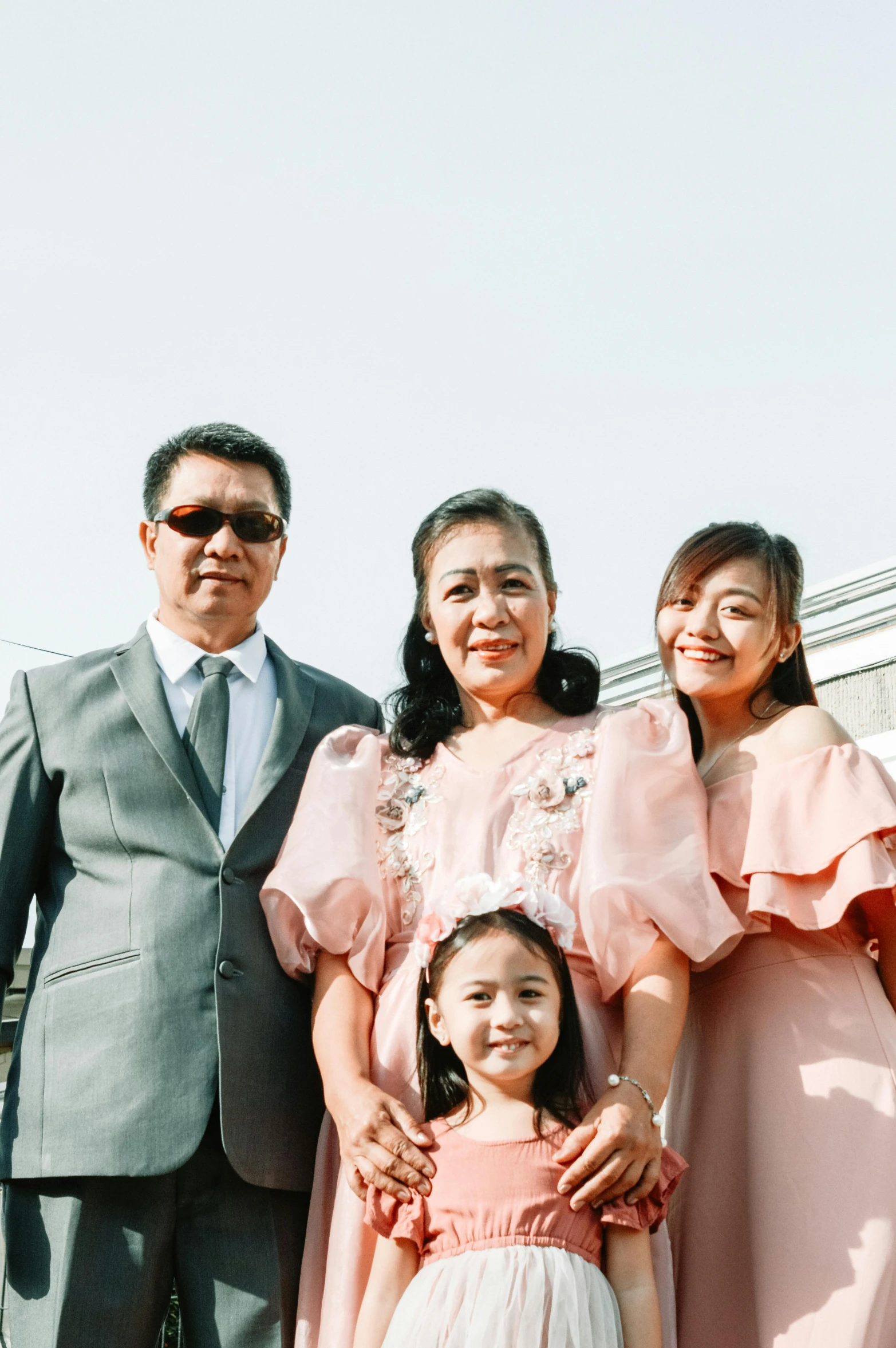 a group of people standing next to each other, a picture, inspired by Ruth Jên, pexels contest winner, portrait of family of three, wearing a formal dress, 15081959 21121991 01012000 4k, medium height