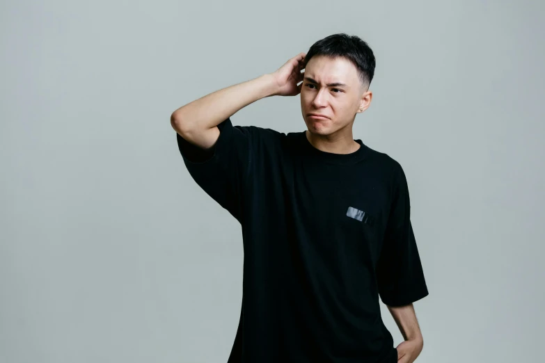 a man standing with his hand on his head, inspired by Gang Hui-an, unsplash, realism, wearing a black tshirt, non binary model, ernie chan, short sleeves