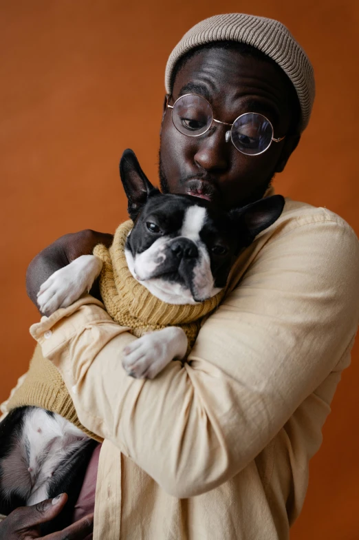 a man holding a dog in his arms, trending on pexels, visual art, adut akech, non binary model, french bulldog, brown:-2